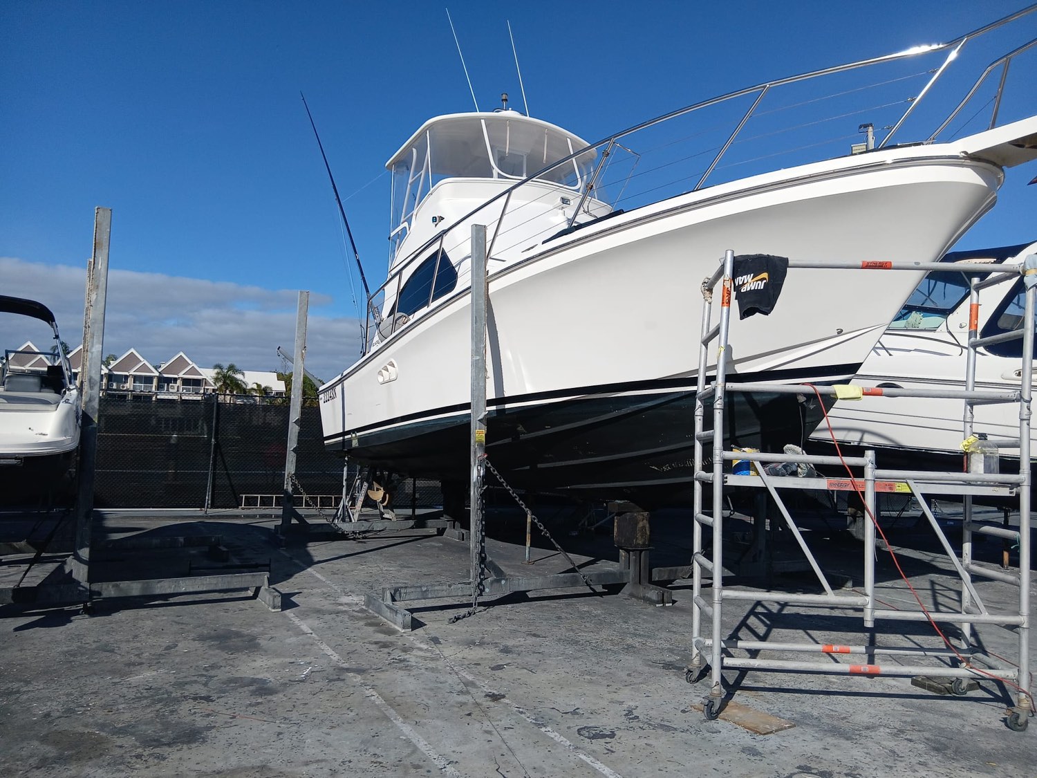 Flybridge cruiser on the hardstand, topsides cut and polished