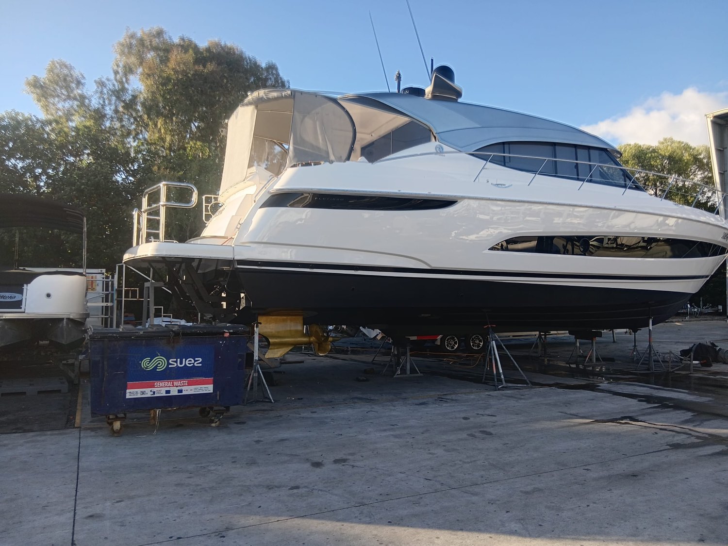 Platinum flybridge cruiser polished to a deep gloss in the boatyard